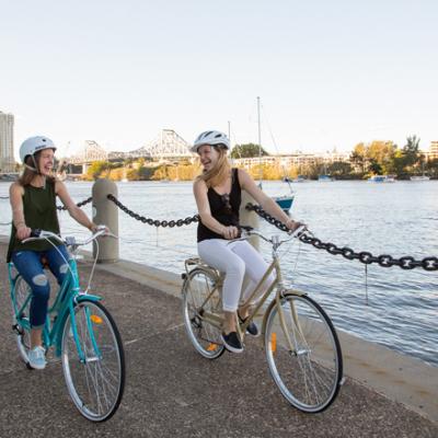 Two friends cycling through Brisbane, Australia