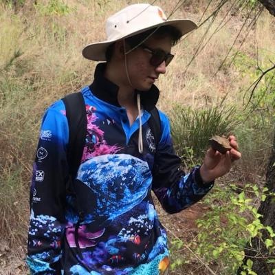 Eric Ward inspects rock while on bush walk