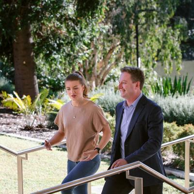 student and lecturer walking together and talking