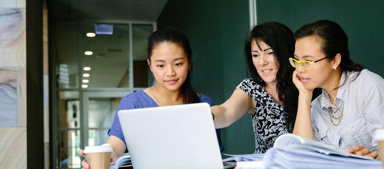 Three women looking at laptop