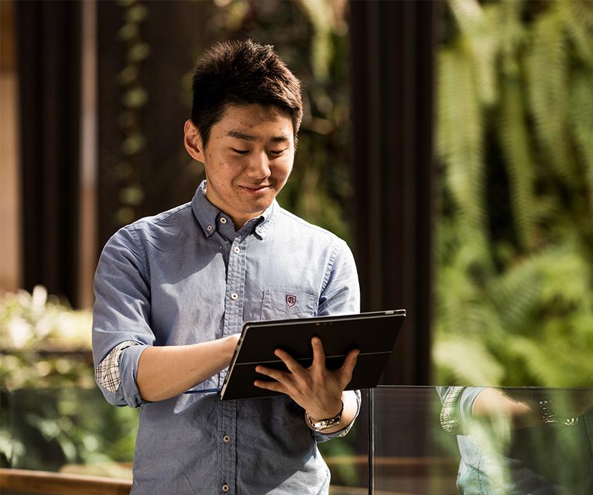 Person using an iPad as they walk.
