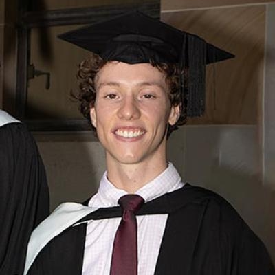 Paterson Naggs wearing a graduation gown and mortarboard