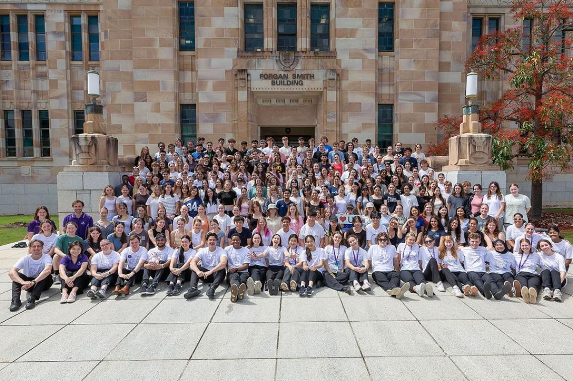 Group of Young ChangeMakers Program participants gathered on steps.